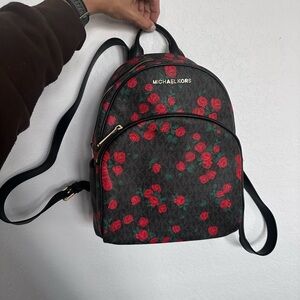 Michael Kors Black Backpack with Red Floral Pattern